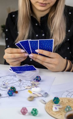 Woman astrologer draws a natal chart. Selective focus. People.