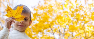 Sonbahar parkında gülümseyen çocuk. Sonbahar.