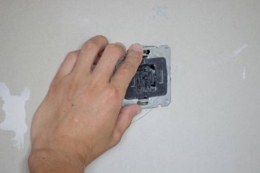 Erkek elektrikçi soket takıyor. Seçici odak.