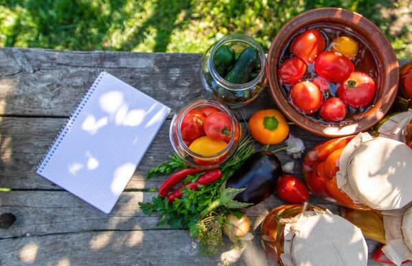 woman canning tomatoes cucumbers vegetables on the background of nature. Selective focus.