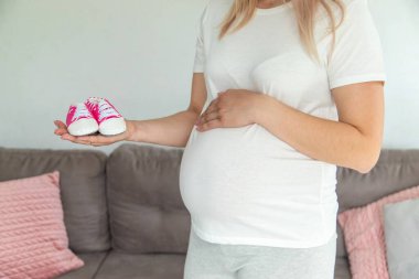 Pregnant woman baby booties belly. Selective focus. cute. clipart