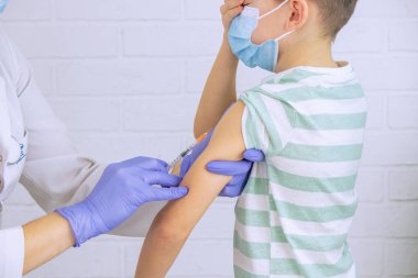 Doktor bir çocuğa aşı yapıyor, bir çocuğa. Çocuk doktorunun ataması, sağlık konsepti.