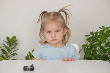 Çocuk bir büyüteç altında suyu inceler ve inceler. Seçici odak.