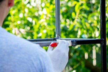 Bahçedeki fırçayla metali boyamaya yakın.