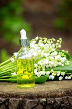 Cam bir şişe nilüfer çiçeği ve taze çiçekli gerekli yağ.