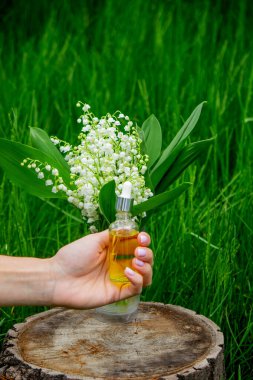 Cam bir şişe nilüfer çiçeği ve taze çiçekli gerekli yağ.