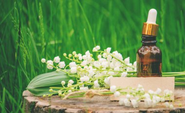 Cam bir şişe nilüfer çiçeği ve taze çiçekli gerekli yağ.