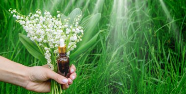 Cam bir şişe nilüfer çiçeği ve taze çiçekli gerekli yağ.