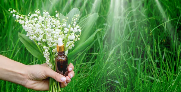 Cam bir şişe nilüfer çiçeği ve taze çiçekli gerekli yağ.