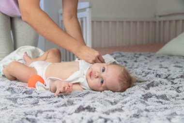 Anne üstünü değiştirip bebek için kıyafet giyer. Bebeğim.