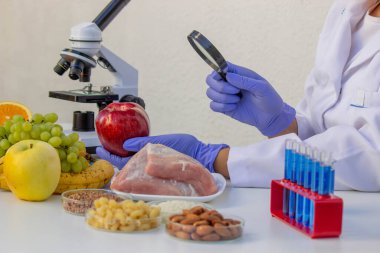 Laboratuvar Gıda Kalitesi Kontrolü Elmayı Büyüteçle İncelemek.