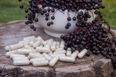 Doğal ilaçlar, kapsüller ve böğürtlenden yapılan bağışıklık takviyeleri.