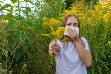 The girl is allergic to ragweed. Seasonal allergies.
