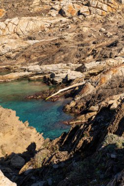 Cap de Creus Alt Emporda, Spain. February 2023 Rugged rocky coastline with turquoise waters in contrast. Sharp rocks extend out to the sea, creating a dramatic and wild texture.