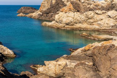 Cap de Creus Alt Emporda, Spain. February 2023 Rugged rocky coastline with turquoise waters in contrast. Sharp rocks extend out to the sea, creating a dramatic and wild texture.