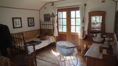 Frutillar, Chile - 12 23 2018: bedroom of wooden farm house of the german colonial museum Frutillar in Patagonia, Chile, a historical german settlement with typical old wooden houses and rich migration history.