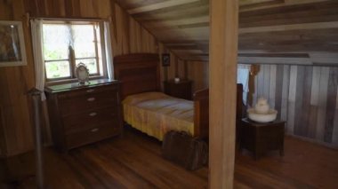 Frutillar, Chile - 12 23 2018: sleeping room of wooden farm house of the german colonial museum Frutillar in Patagonia, Chile, a historical german settlement with typical old wooden houses and rich migration history.