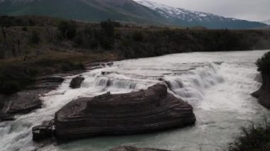 waterfall in the iconic Torres del paine national in Patagonia, Chile, south America, on a cloudy and overcast day.