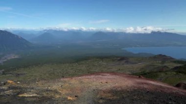 view over the volcanic landscape and a deep blue lake at the Osorno volcano in Patagonia, south America.