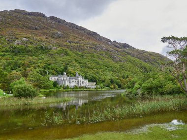 Galway, Ireland 09 16 2015: Kylemore Abbey in the landscape of the lush and green Connemara National Park, a popular travel destination for hiking and recreation in Ireland