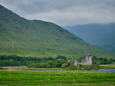 Kilchurn Kalesi 'nin kalıntıları, İskoçya dağlarında, Loch Awe' da bulutlu bir günde..