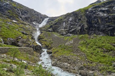 Norveç 'in dağlarındaki Trollstigen manzaralı yolda bir dağ manzarasında şelale.