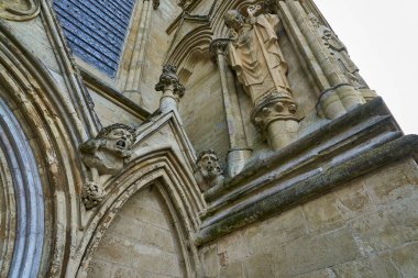 tall Salisbury Cathedral, formally known as the Cathedral Church of the Blessed Virgin Mary, an Anglican cathedral in Salisbury, England, popular travel destination in great britain, united kingdom. clipart