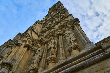 tall Salisbury Cathedral, formally known as the Cathedral Church of the Blessed Virgin Mary, an Anglican cathedral in Salisbury, England, popular travel destination in great britain, united kingdom. clipart