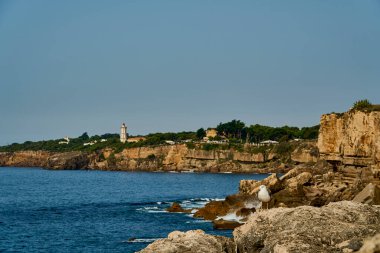 Lizbon 'daki Atlantik Okyanusu' nun kayalık kıyı şeridi, Portekiz 'in başkenti Tagus nehrinin ağzında, Güney Avrupa' nın güneşli bir gününde okyanusun mavi suyuyla..