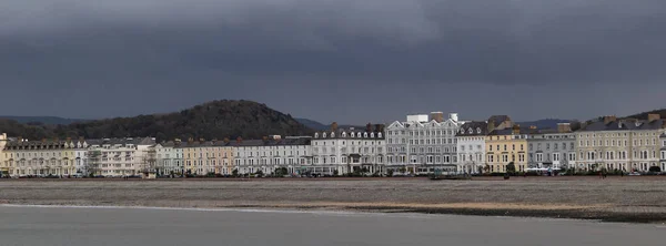 stock image Banner with a view of a seaside town and a dark sky during the rain. Llandudno, Wales, United Kingdom.