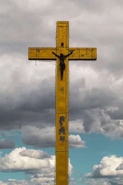 A large cross on a cloudy background. Cross in the sky.