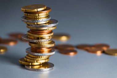 Coins stacked in a slanted pile. Pile of different euro coins and cents.