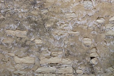 Alçı desenli antik taş duvarın bej arka planı. Sarı kahverengi eski duvar dokusu.