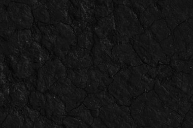 Çatlaklı kara zeminin siyah arka planı. Koyu renk çatlamış, yerdeki siyah çatlaklar..