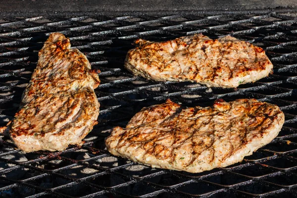 stock image Pork steak barbecue. Juicy steaks grilled on the grill. Close-up of steaks grilled on charcoal.