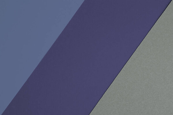 Tricolor paper background in shades of blue and gray. Textured paper background.