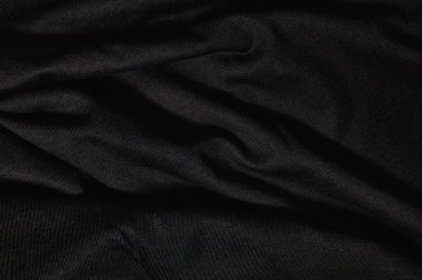 Siyah kumaş dokusunun koyu dalgalı arkaplanı.