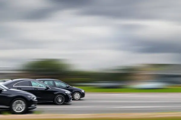 stock image Fast moving cars on highway with motion blur background. Concept of speeding, illegal car racing, dangerous driving.