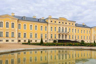 Rundale Castle with the reflection of the facade in the water. Pilsrundale, Rundale Castle, Latvia. clipart