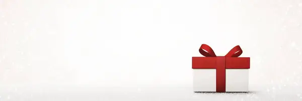 Noel kutlamaları ve kış tasarımı için kırmızı kurdeleli bayram hediyesi kutusu..