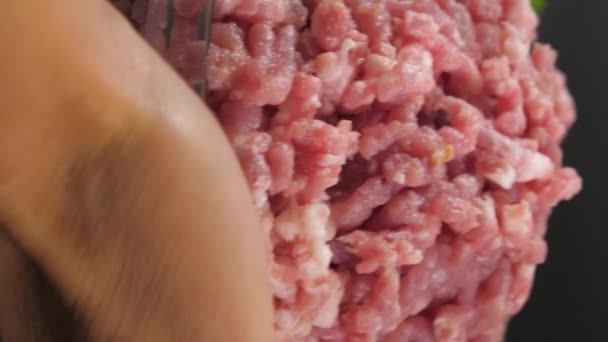 垂直录像 紧紧抓住人类的手 把一个装有小牛肉 鸡肉和猪肉的玻璃碗放在黑暗的背景上 背景是欧芹 西红柿 — 图库视频影像
