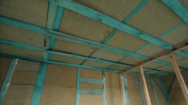 Insulation in framed wood wooden walls basalt mineral wool. Walls in a new building. Construction of shelters.