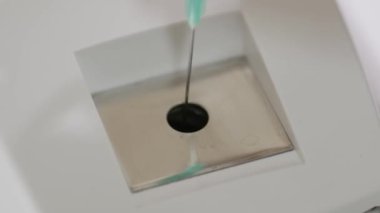 Close-up of burning needles in a medical destructor burning used syringes. Flashes of sparks. Disposal and disinfection.