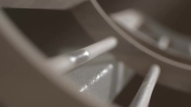 The process of applying a primer from remote control paint to a wooden part. Close-up shot. Production of furniture.