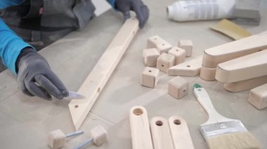 Close Up Of Worker Using Spatula Tool To Manually Apply Putty On Woodwork. Manual Woodwork Improvement. Manually Coating Putty On Cracks In Lumber Material. Woodworking Putty.