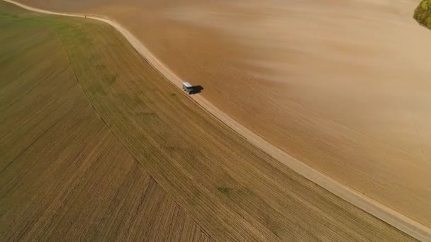 Green Suv White Roof Drives Dirt Road Two Fields Diagonally — Stock Video