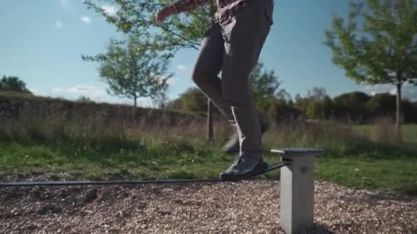 Man Beginner Learns How Walk Balance Slackline Sneakers Outdoors Germany — Stock Video