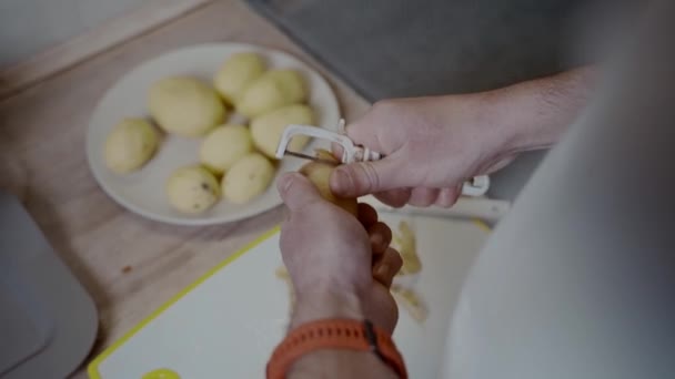 Kawaler Przygotowuje Kolację Domu Kuchni Zdrowe Jedzenie Mężczyzna Obiera Skórę — Wideo stockowe