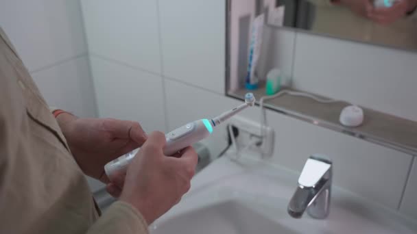 Close Male Hand Turning Ultrasonic Toothbrush White Blue Backlight Background — Stock Video