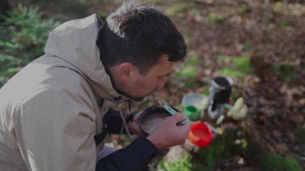 Male Hiker Eats Quick Porridge Tourist Bowl Forest Trip Sublimated — Vídeo de Stock